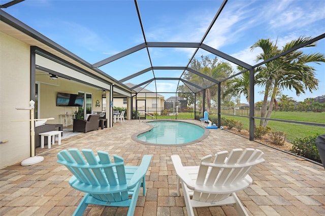 view of pool with a patio, a lanai, and ceiling fan