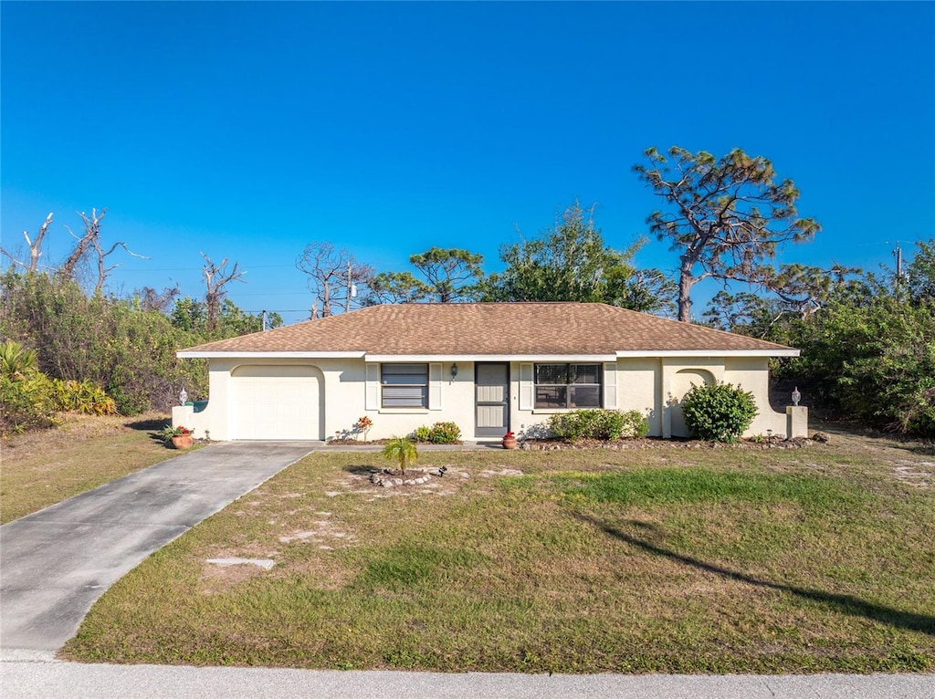 single story home featuring a garage and a front lawn