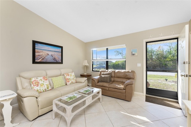 living room with light tile patterned floors and vaulted ceiling