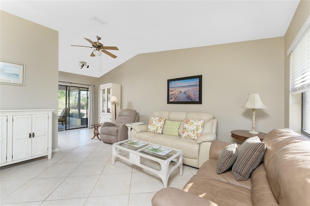 living room featuring ceiling fan, lofted ceiling, and light tile patterned floors