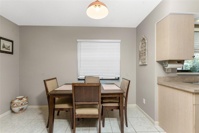 dining room with light tile patterned floors and a textured ceiling