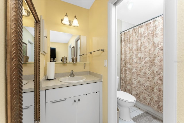 bathroom with tile patterned flooring, vanity, a shower with curtain, and toilet