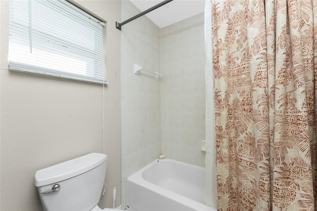 bathroom with shower / bathtub combination with curtain and toilet