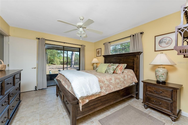 bedroom with multiple windows, access to outside, and ceiling fan