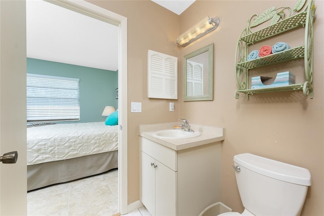 bathroom featuring tile patterned floors, vanity, and toilet