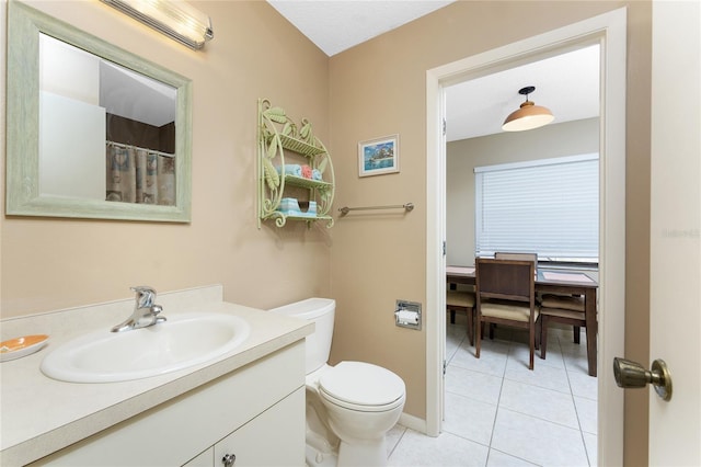 bathroom with vanity, tile patterned floors, and toilet