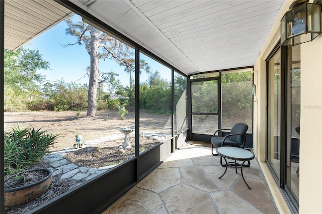 sunroom featuring vaulted ceiling