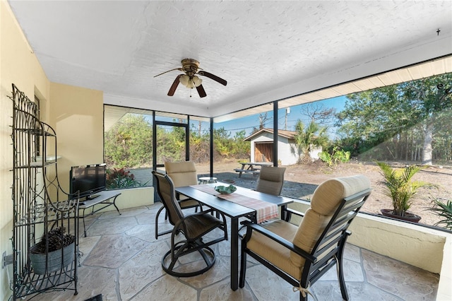 sunroom featuring ceiling fan