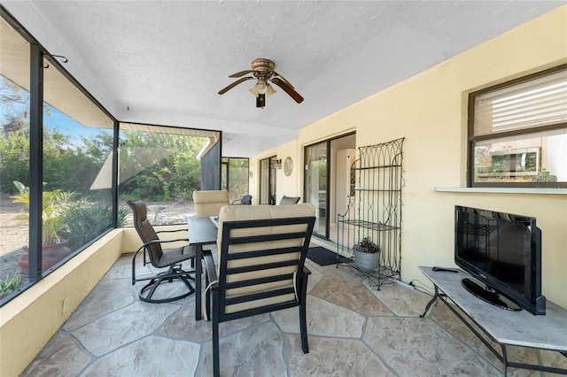 sunroom featuring ceiling fan