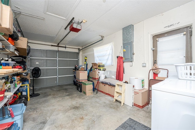 garage featuring washer / clothes dryer, a garage door opener, and electric panel