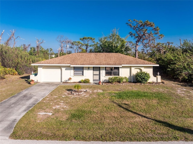 single story home with a garage and a front lawn