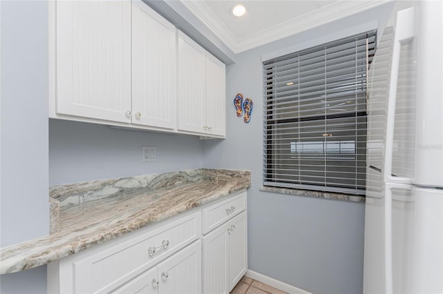 kitchen with recessed lighting, ornamental molding, white cabinets, light stone countertops, and baseboards