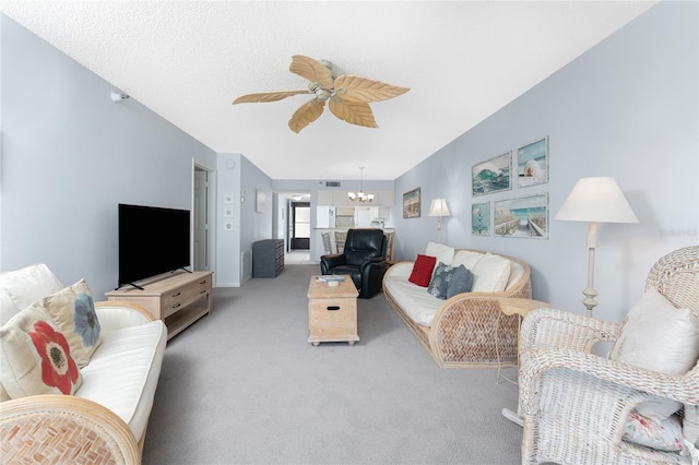 carpeted living area featuring ceiling fan with notable chandelier