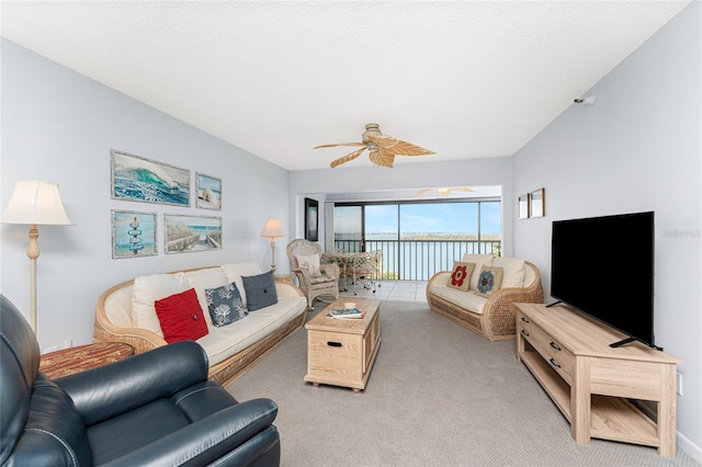 carpeted living room featuring a textured ceiling and a ceiling fan