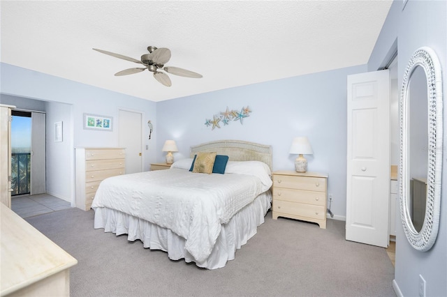 bedroom featuring ceiling fan, carpet floors, a textured ceiling, and baseboards