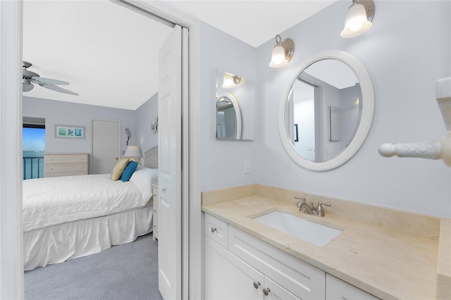 ensuite bathroom with ensuite bath, ceiling fan, and vanity