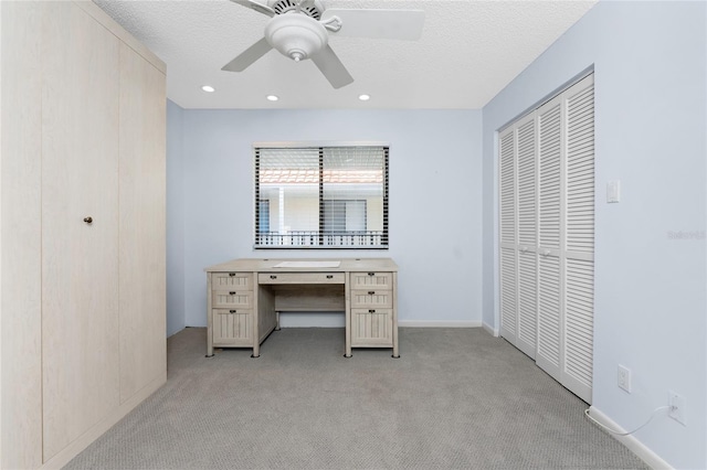 unfurnished office with recessed lighting, light carpet, ceiling fan, and a textured ceiling