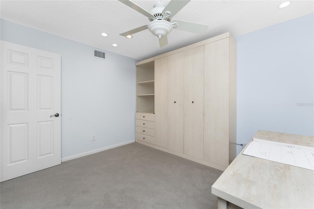 unfurnished bedroom with visible vents, a textured ceiling, carpet flooring, a closet, and recessed lighting