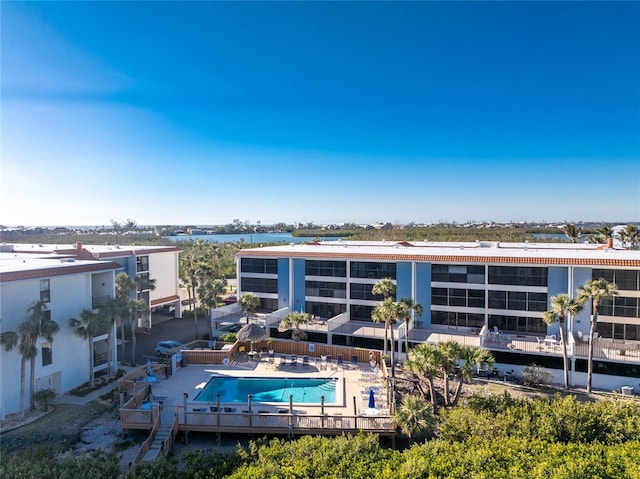 rear view of property with a community pool