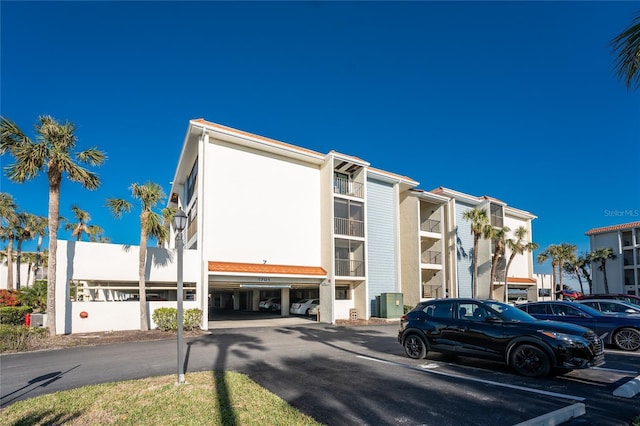 view of property featuring uncovered parking