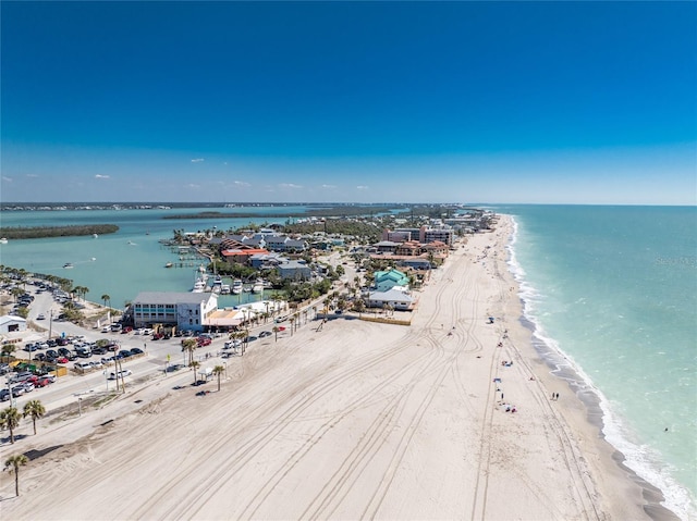 drone / aerial view with a water view and a beach view