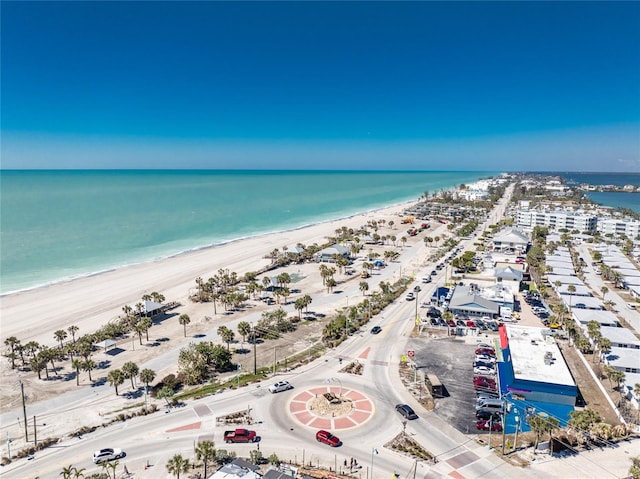 birds eye view of property with a water view and a beach view