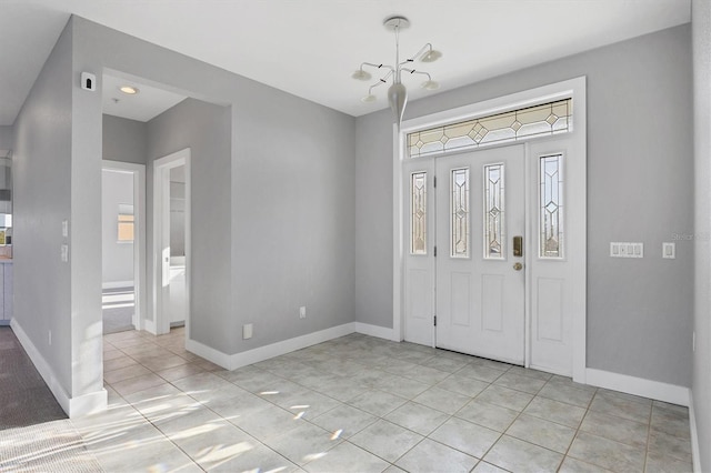 foyer entrance featuring light tile patterned flooring and a notable chandelier