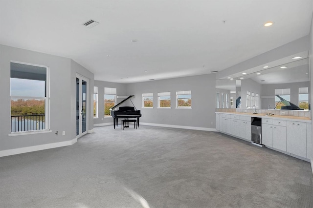 interior space with lofted ceiling and light colored carpet