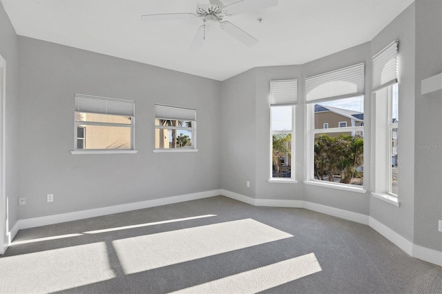 unfurnished room with ceiling fan, a healthy amount of sunlight, and carpet flooring