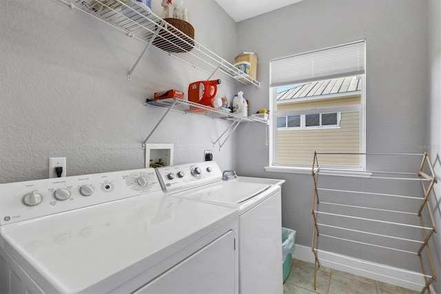 washroom featuring light tile patterned floors and independent washer and dryer