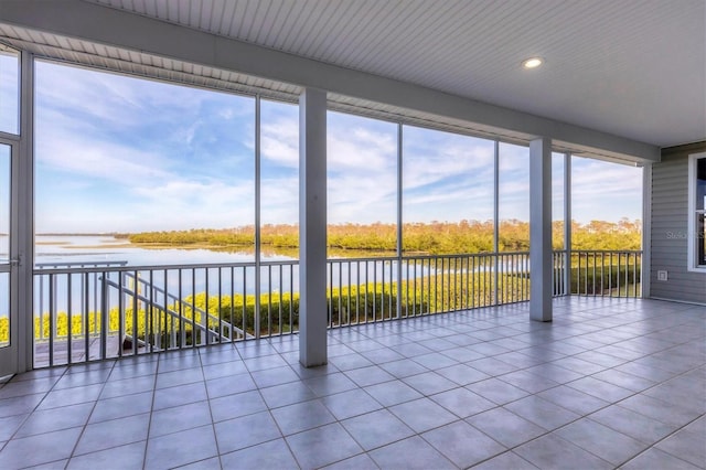 unfurnished sunroom with a water view