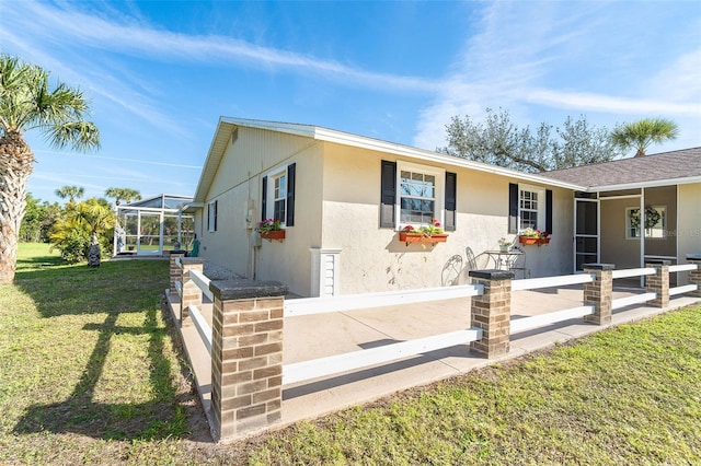 view of front of home with a front yard and stucco siding