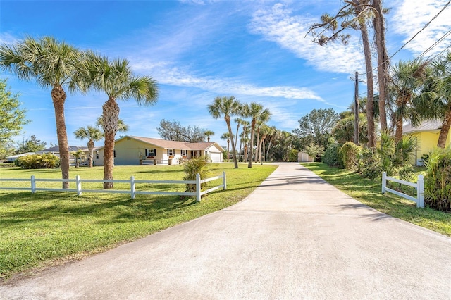 view of road featuring concrete driveway