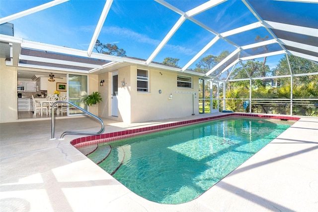 outdoor pool with a lanai and a patio area