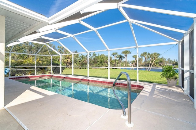 outdoor pool with glass enclosure, a lawn, a patio area, and a water view