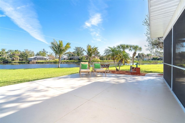 surrounding community with a water view, a lawn, and a patio