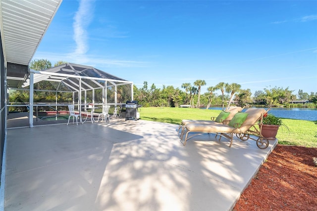 view of patio with a lanai, a water view, and a grill