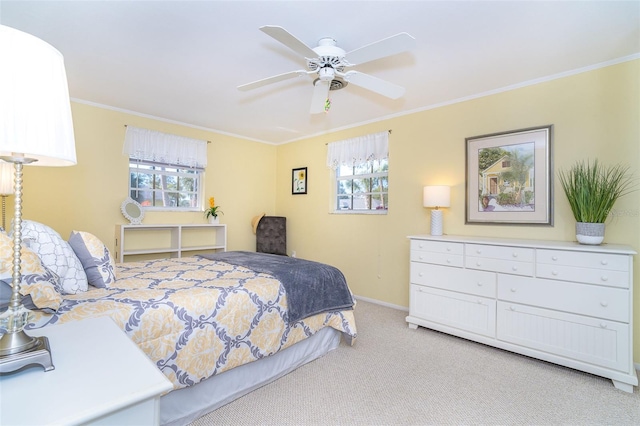 bedroom with ornamental molding, a ceiling fan, light carpet, and multiple windows