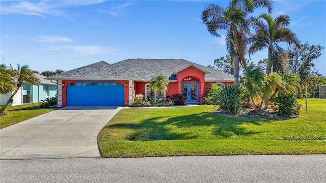 single story home with french doors, a garage, and a front lawn