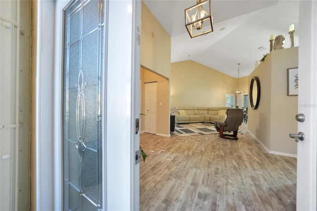 interior space featuring vaulted ceiling and light wood-type flooring