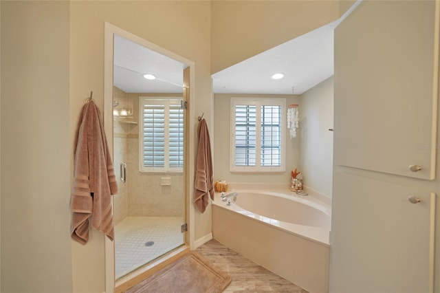 bathroom with separate shower and tub