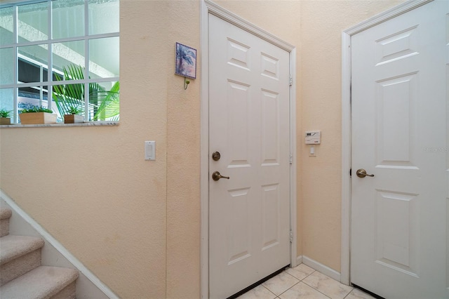 doorway to outside featuring light tile patterned flooring