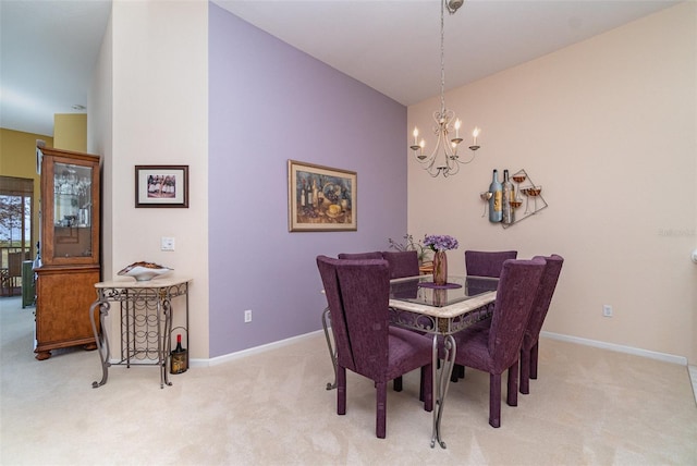 dining area with light carpet and an inviting chandelier