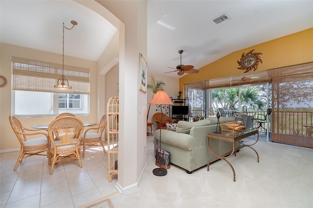 living room with lofted ceiling, ceiling fan, a healthy amount of sunlight, and light tile patterned flooring