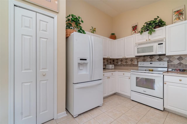 kitchen featuring white cabinetry, light tile patterned floors, white appliances, and decorative backsplash