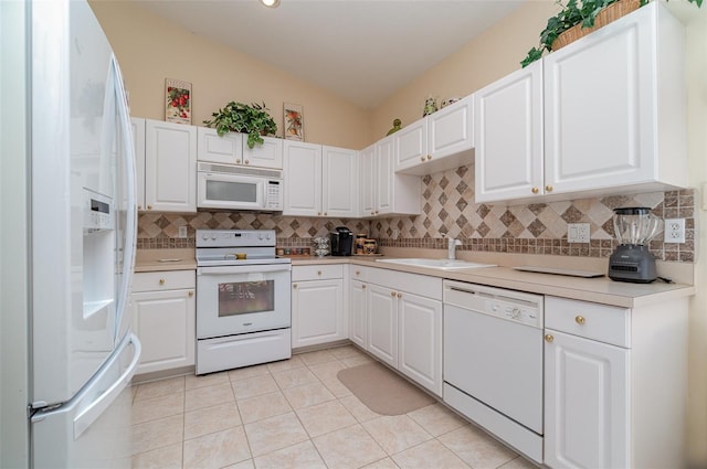 kitchen with sink, white cabinets, decorative backsplash, light tile patterned floors, and white appliances