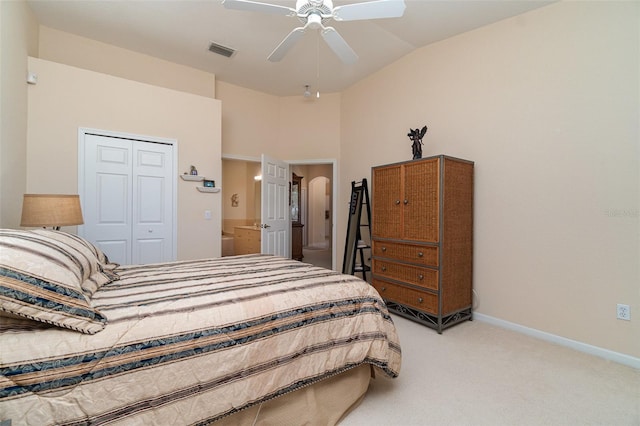 bedroom with high vaulted ceiling, light colored carpet, ceiling fan, and a closet