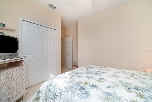 carpeted bedroom featuring a closet and ceiling fan