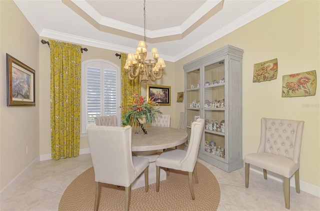 tiled dining space featuring a raised ceiling, crown molding, and a chandelier