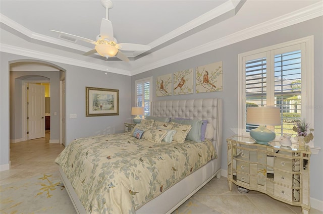 tiled bedroom featuring crown molding and a raised ceiling